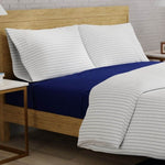 organic percale navy stripe pillowcases on bed