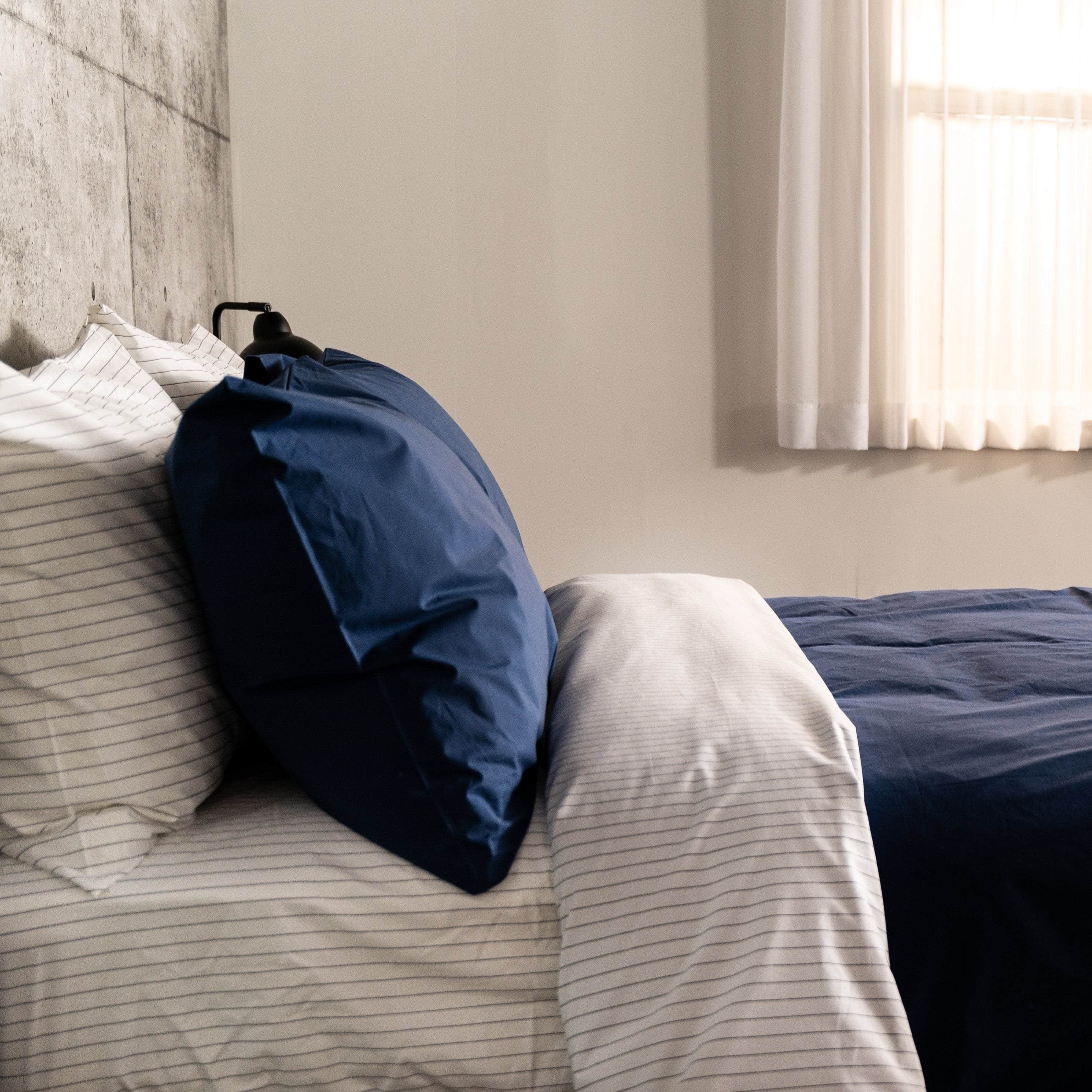 Organic Percale Navy Pillowcase on bed