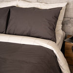 Bed featuring the Organic Percale Pillowcases in Charcoal and in Light Grey Frame