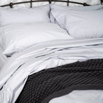 Bed featuring the Organic Percale Pillowcases in Light Grey