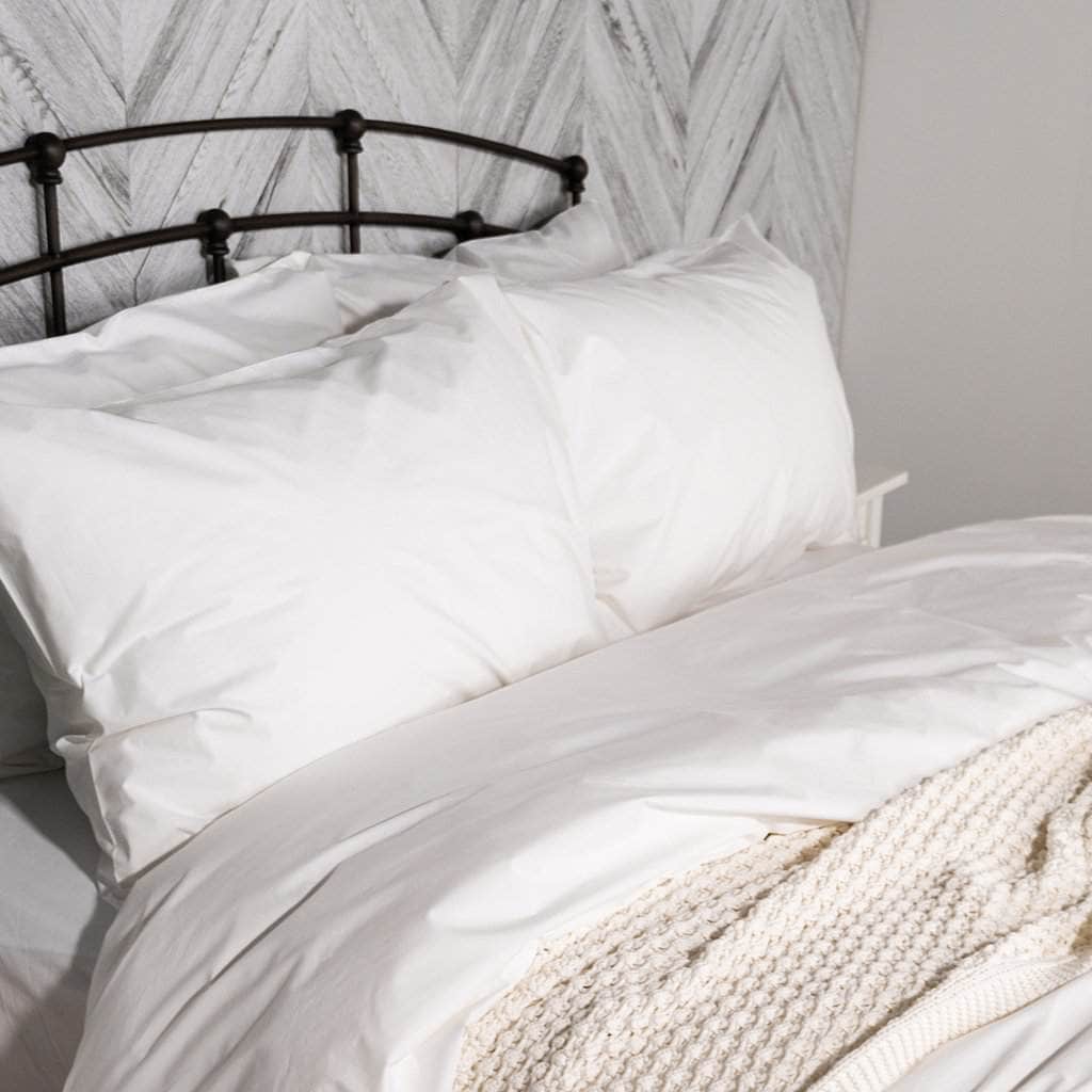 Bed featuring the Organic Percale Pillowcases in White