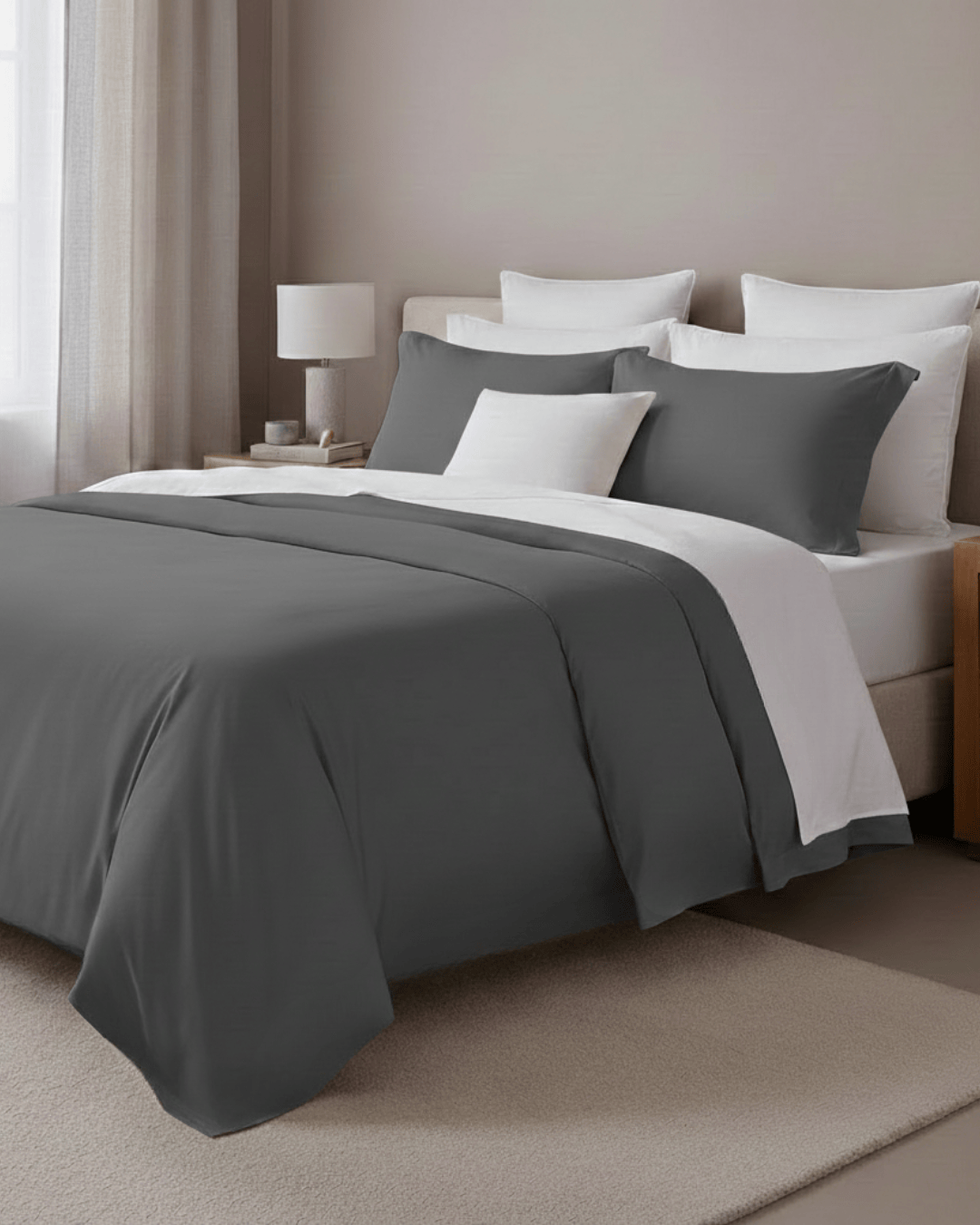 Bed with gray and white bedding in a bedroom setting