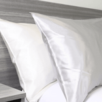 White and Silver Grey Silk pillows on a bed| Skylark+Owl Linen Co.