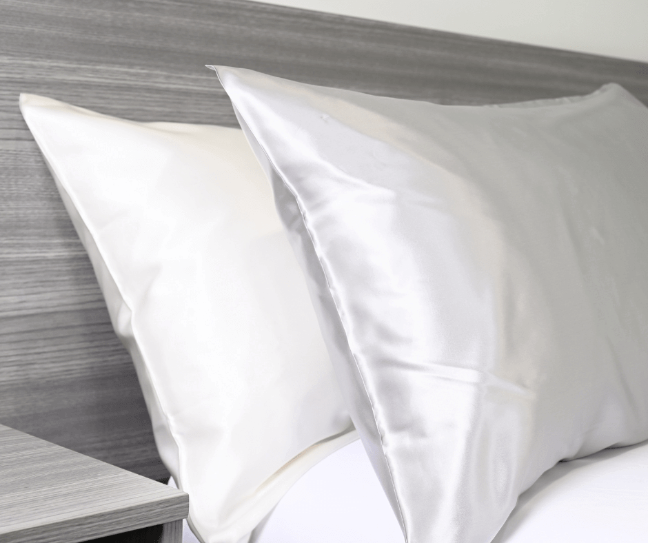 White and Charcoal silk pillows on a bed| Skylark+Owl Linen Co.