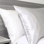 White and Charcoal silk pillows on a bed| Skylark+Owl Linen Co.
