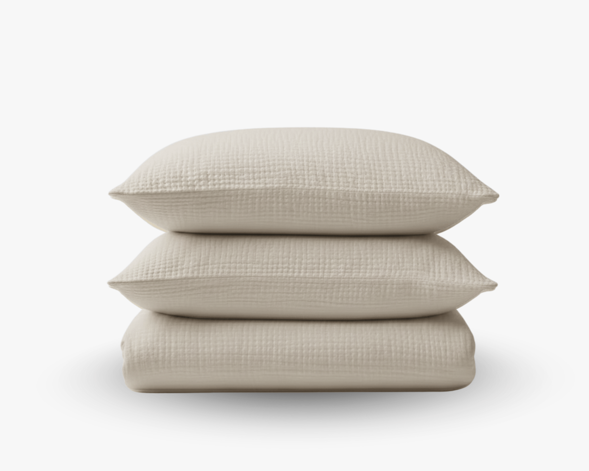 Stacked white cotton gauze duvet cover and pillowcase set