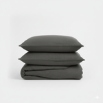 Stack of dark gray textured pillows on a white background