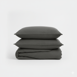 Stack of dark gray textured pillows on a white background