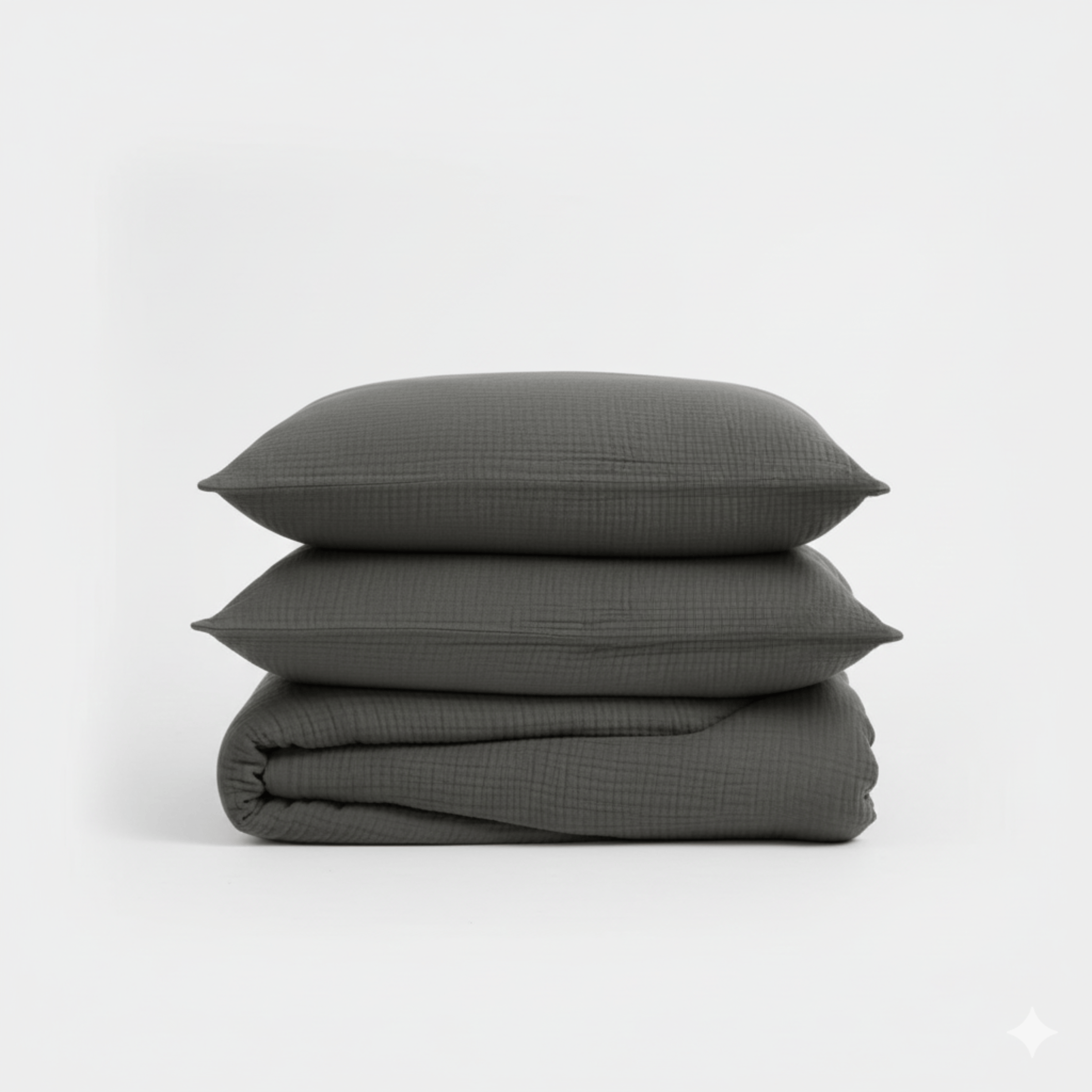 Stack of dark gray textured pillows on a white background