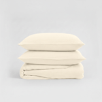 Stack of beige folded fabric on a light gray background