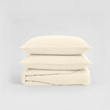 Stack of beige folded fabric on a light gray background
