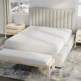 Image of a bed in a neutral colored room with just a white Cooling 5-Sided Mattress Protector on the bed