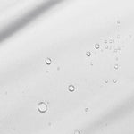 Close-up image of water droplets on a mattress protector
