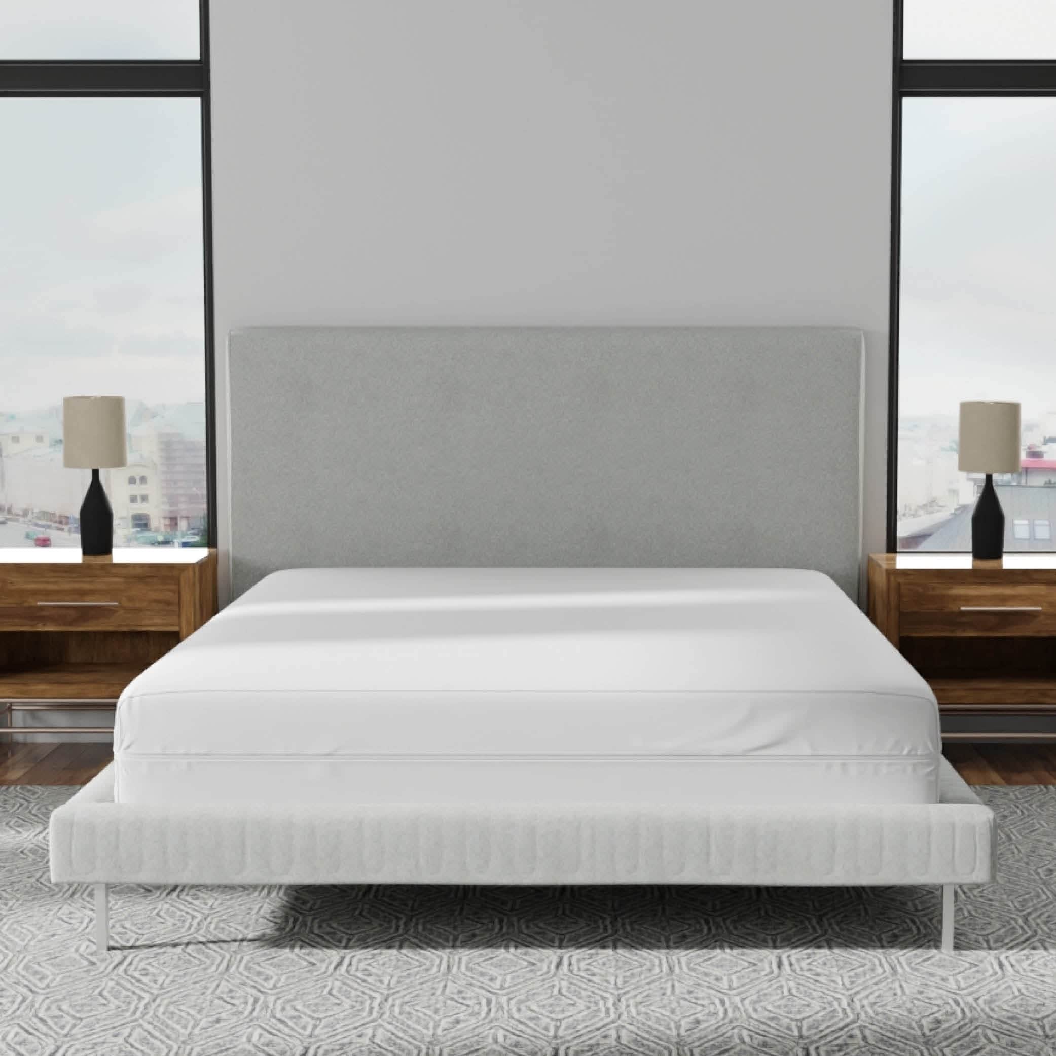 Image of a mattress encasement on a bed with a gray headboard