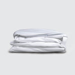 Image of a folded white mattress encasement on a white background