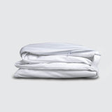Image of a folded white mattress encasement on a white background