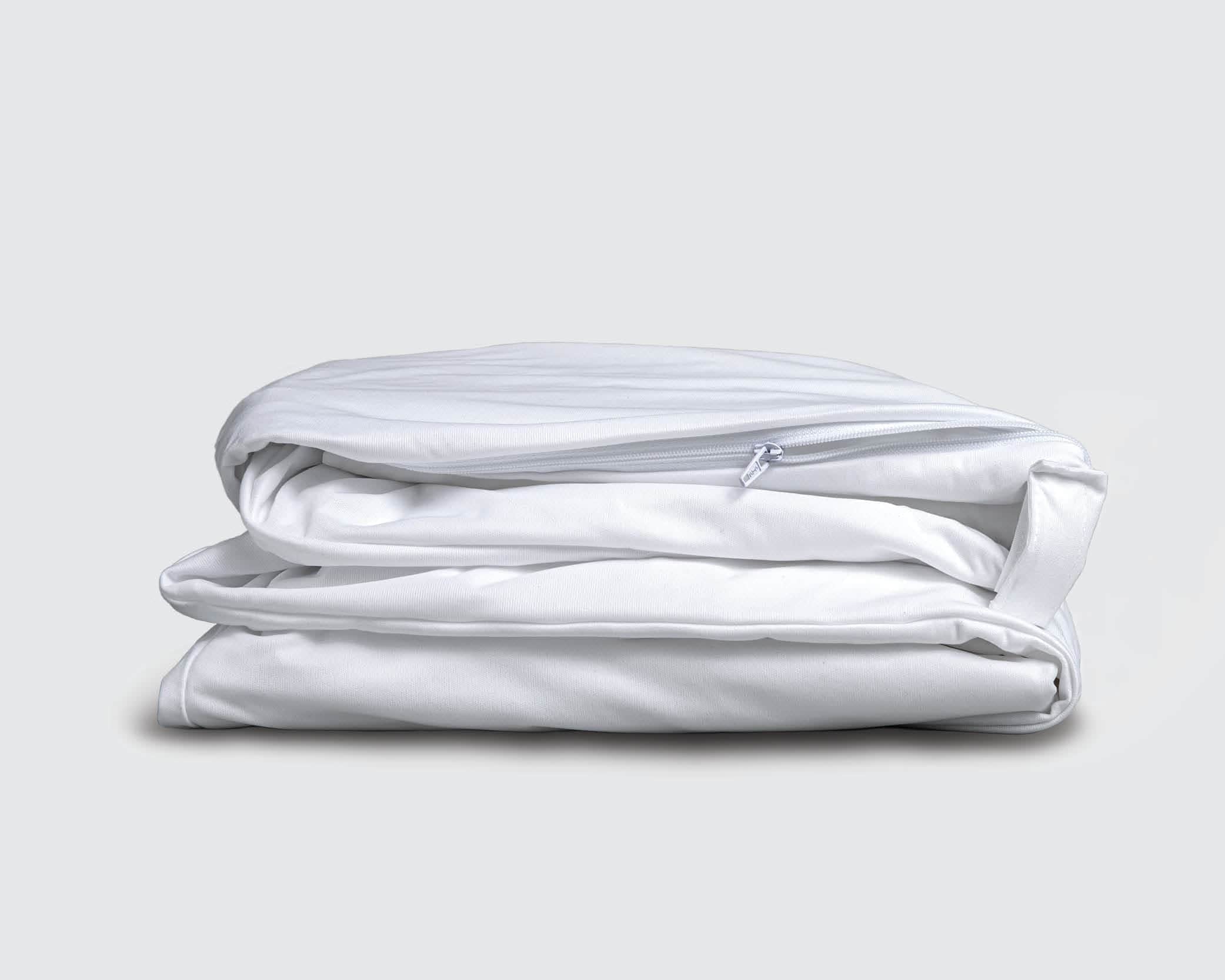 Image of a folded white mattress encasement on a white background