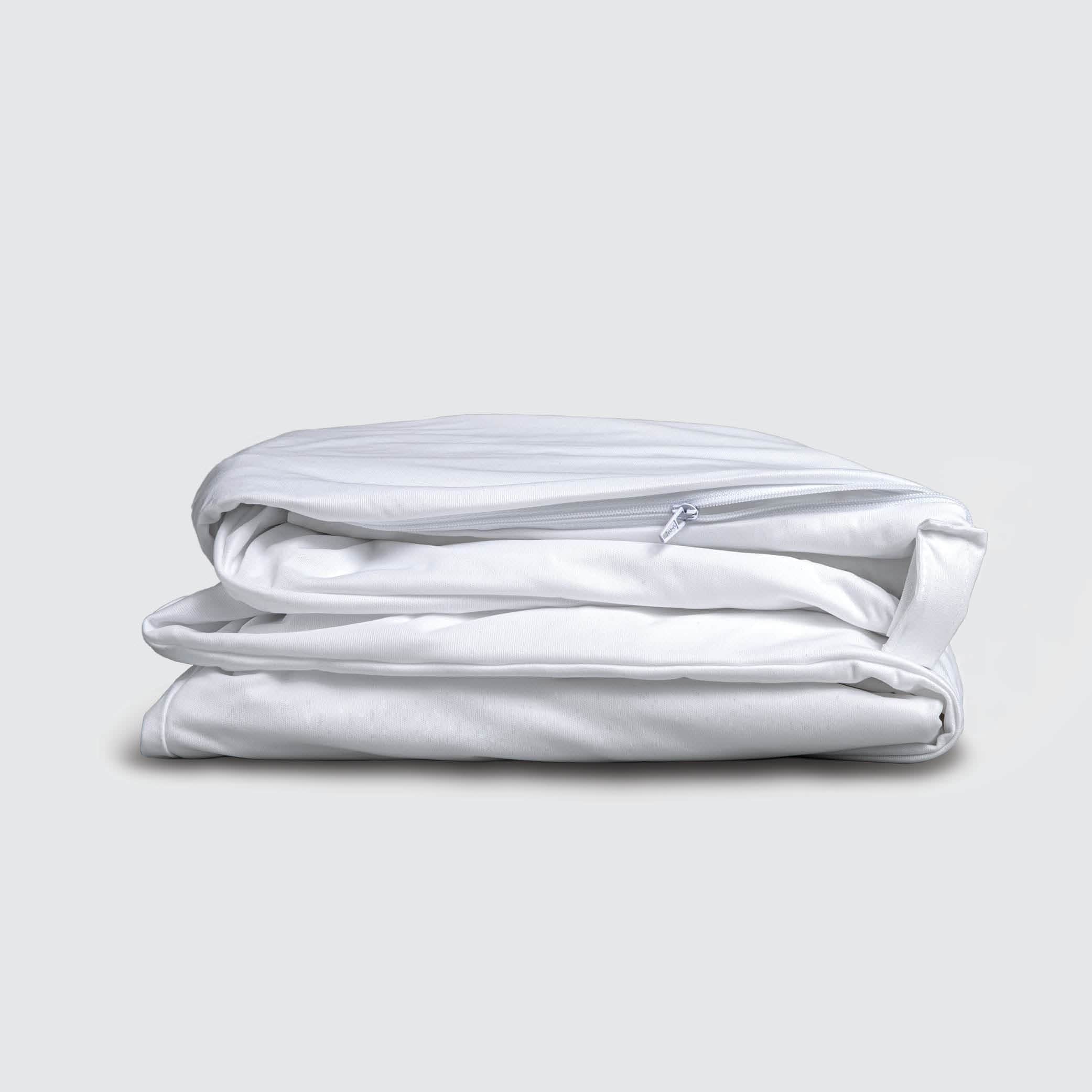 Image of a folded white mattress encasement on a white background