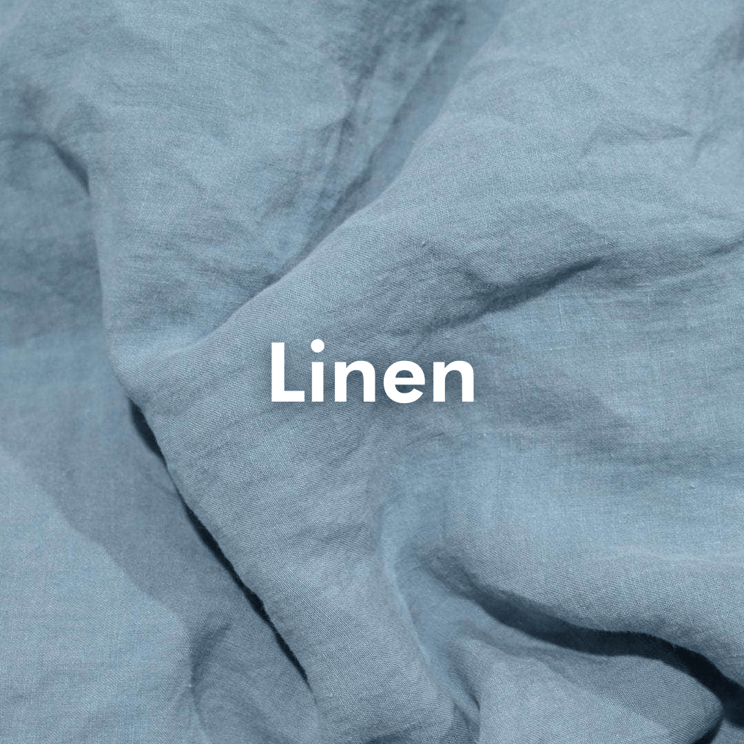 Close-up of blue linen fabric with the word 'Linen' displayed.