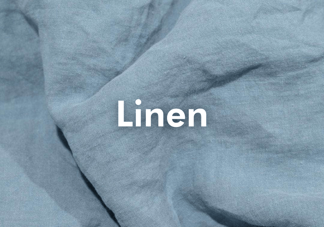 Close-up of blue linen fabric with the word 'Linen' displayed.