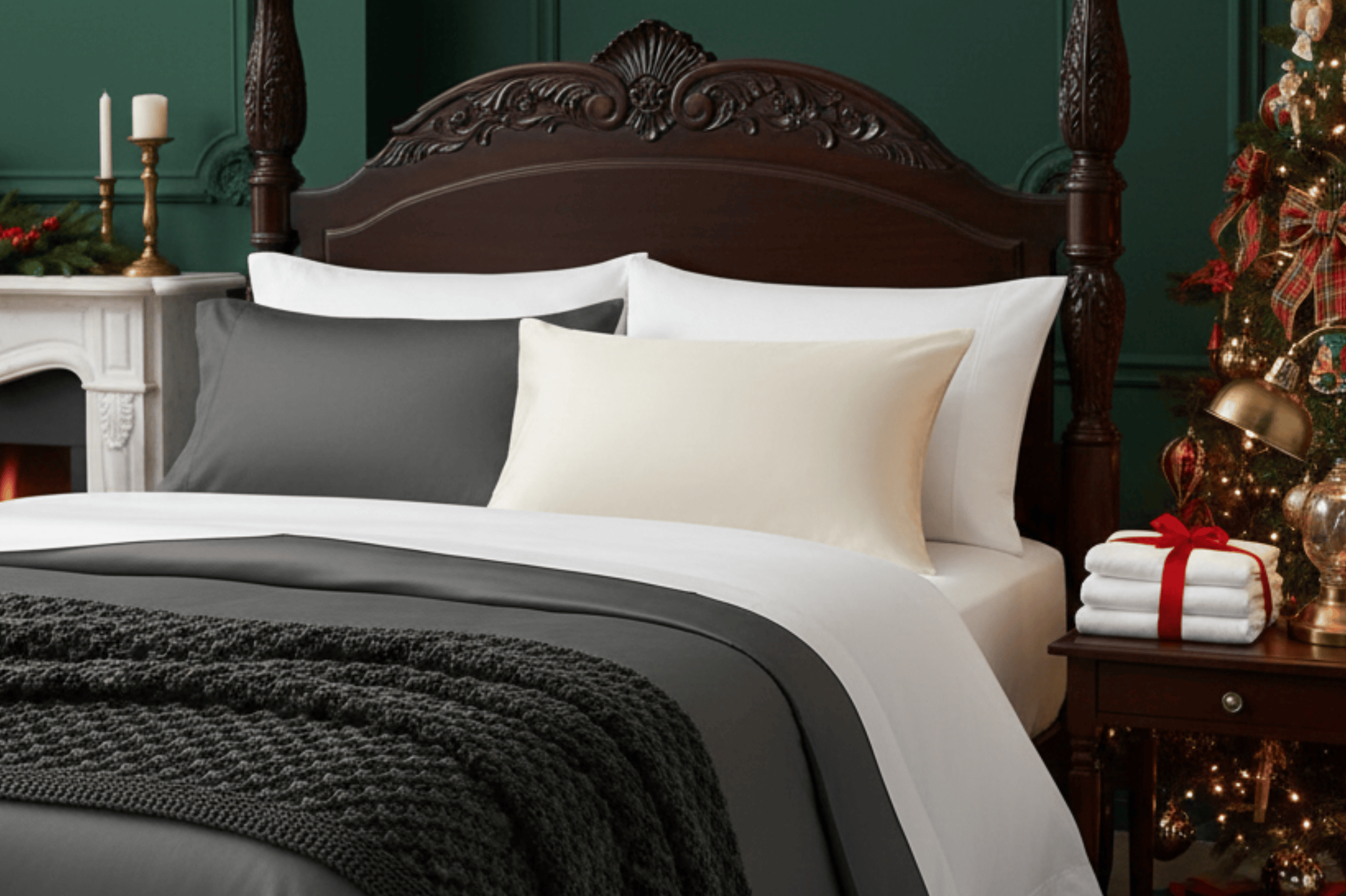 Decorative bedroom with a bed, Christmas tree, and gift-wrapped items.