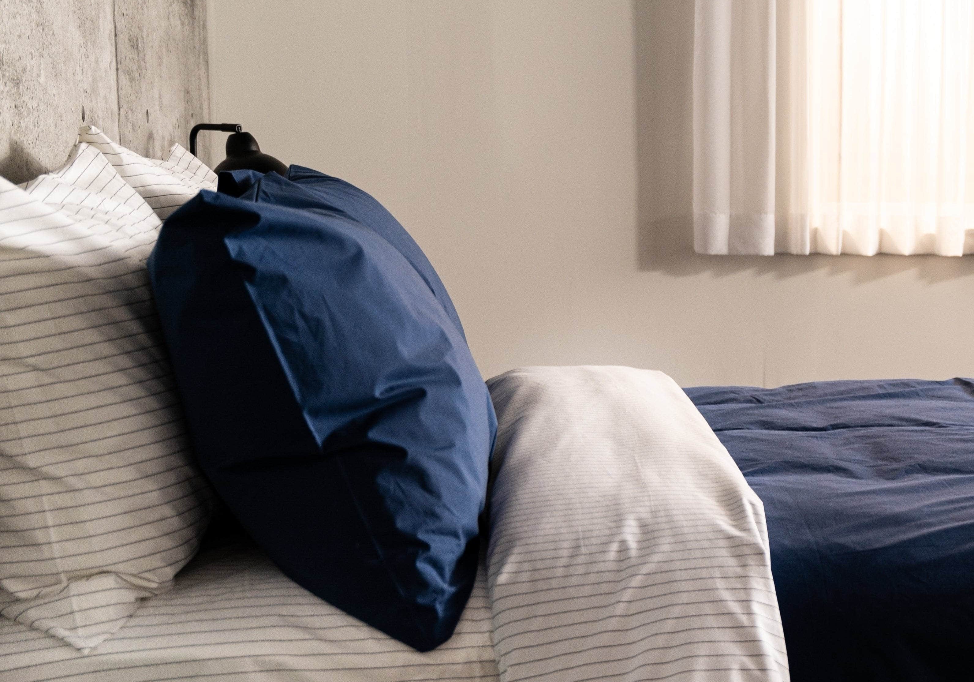 Organic Percale Navy Pillowcase on bed
