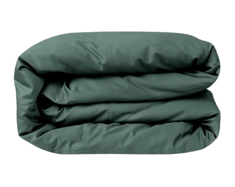 Folded green comforter on a white background