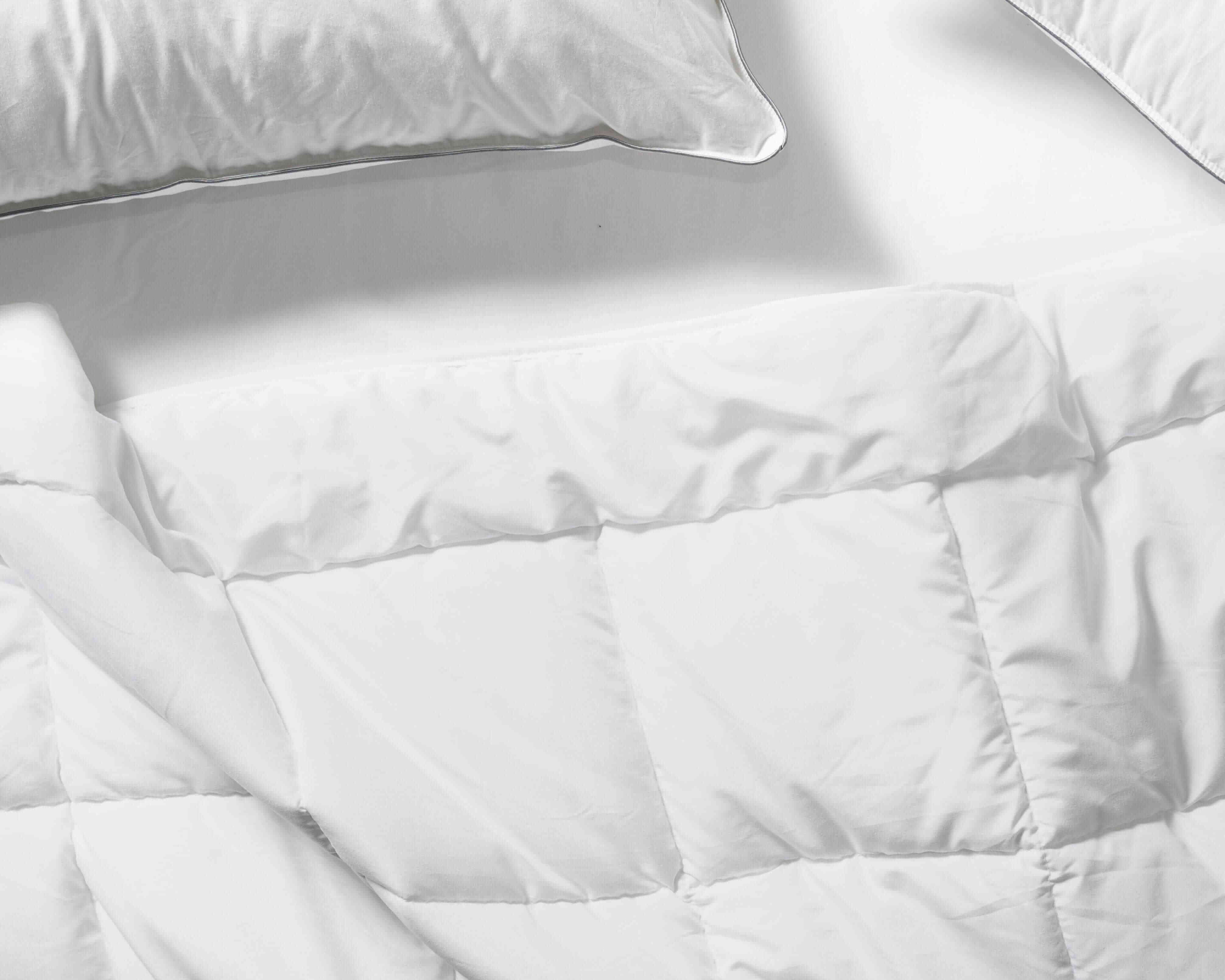 Flay lay of Down Alternative Duvet Blanket with Essential Pillows
