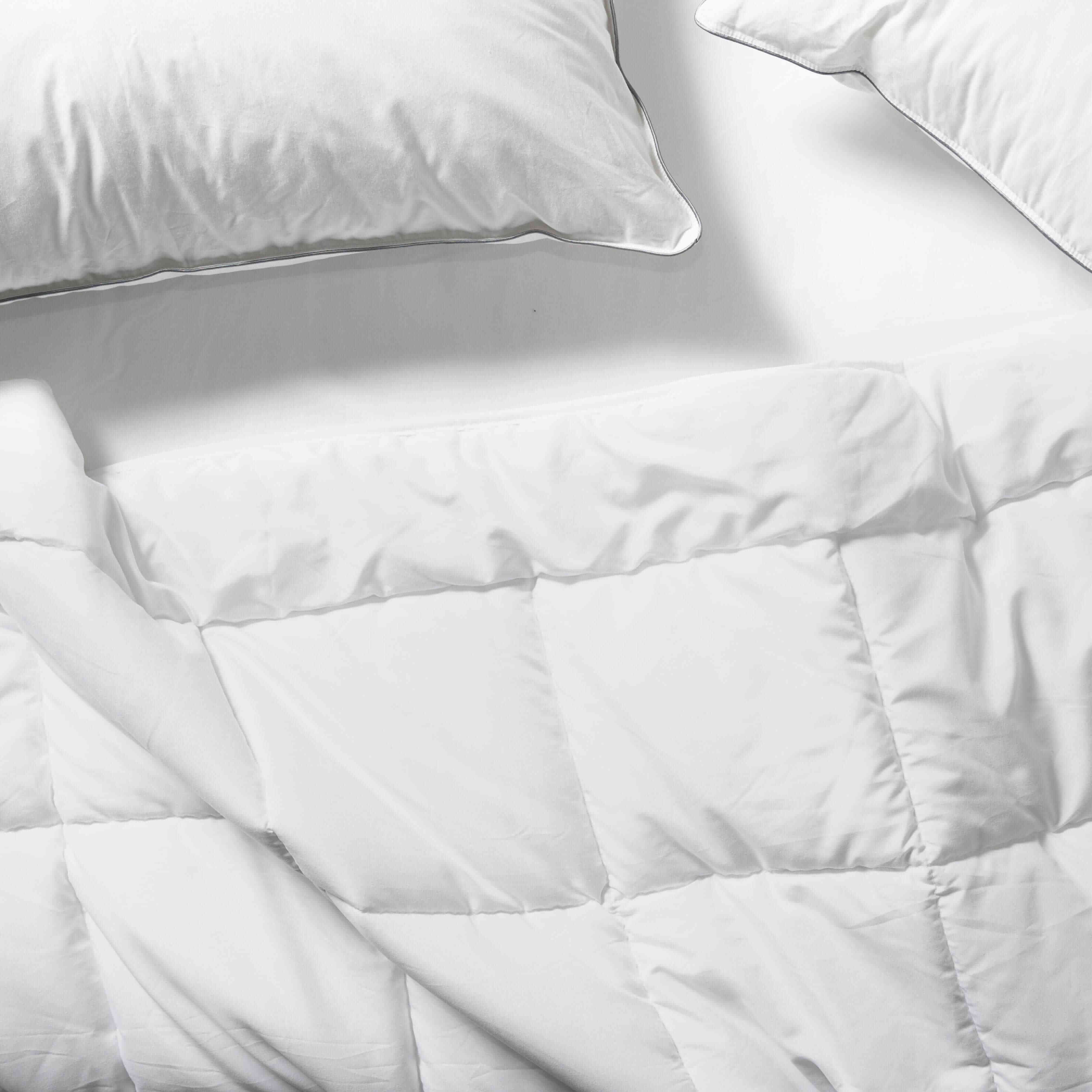 Flay lay of Down Alternative Duvet Blanket with Essential Pillows