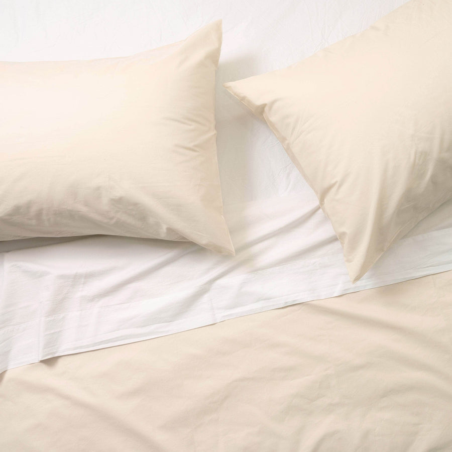 Flat lay of Essential Collection Percale Sheet Set in Dune
