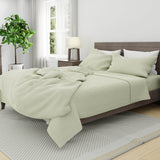 Bed with linen duvet cover in seafoam and white linen pillow cases