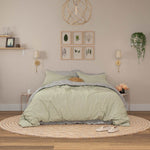 Bed featuring seafoam linen duvet cover and Mushroom linen sheet set.