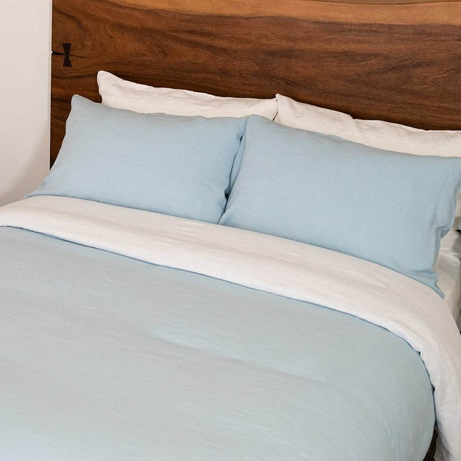 Bed featuring Linen Pillowcases and Linen Duvet Cover in Blue Mist with Linen Sheet Set in White