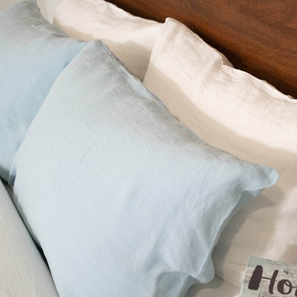 close up of 4 pillows with 2 Blue Mist pillowcases 2 White  pillow cases