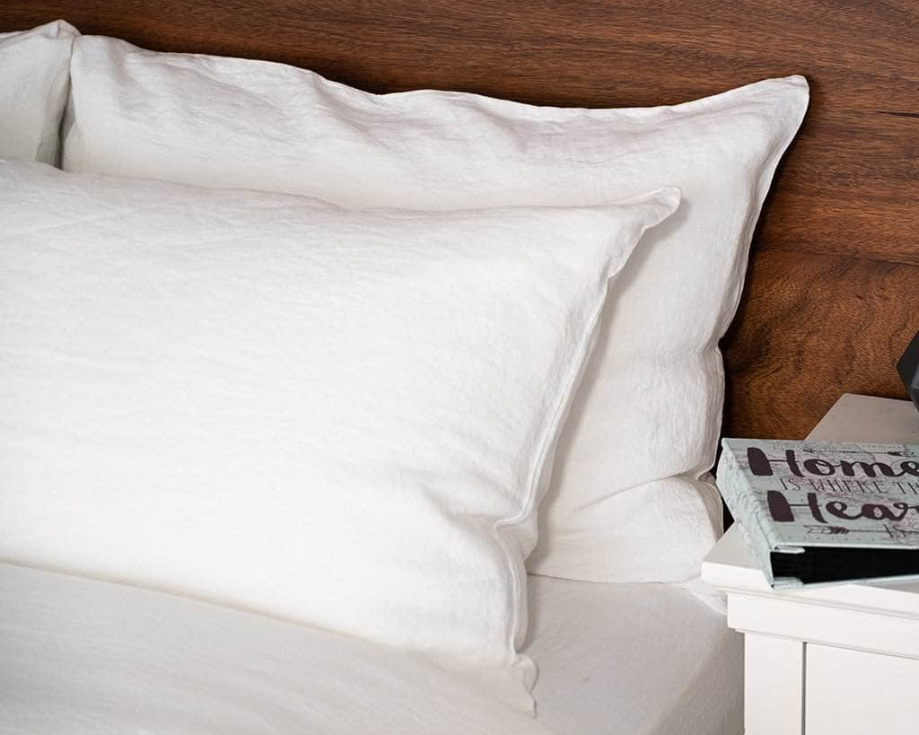 Close up of Linen Pillowcases in White on a bed