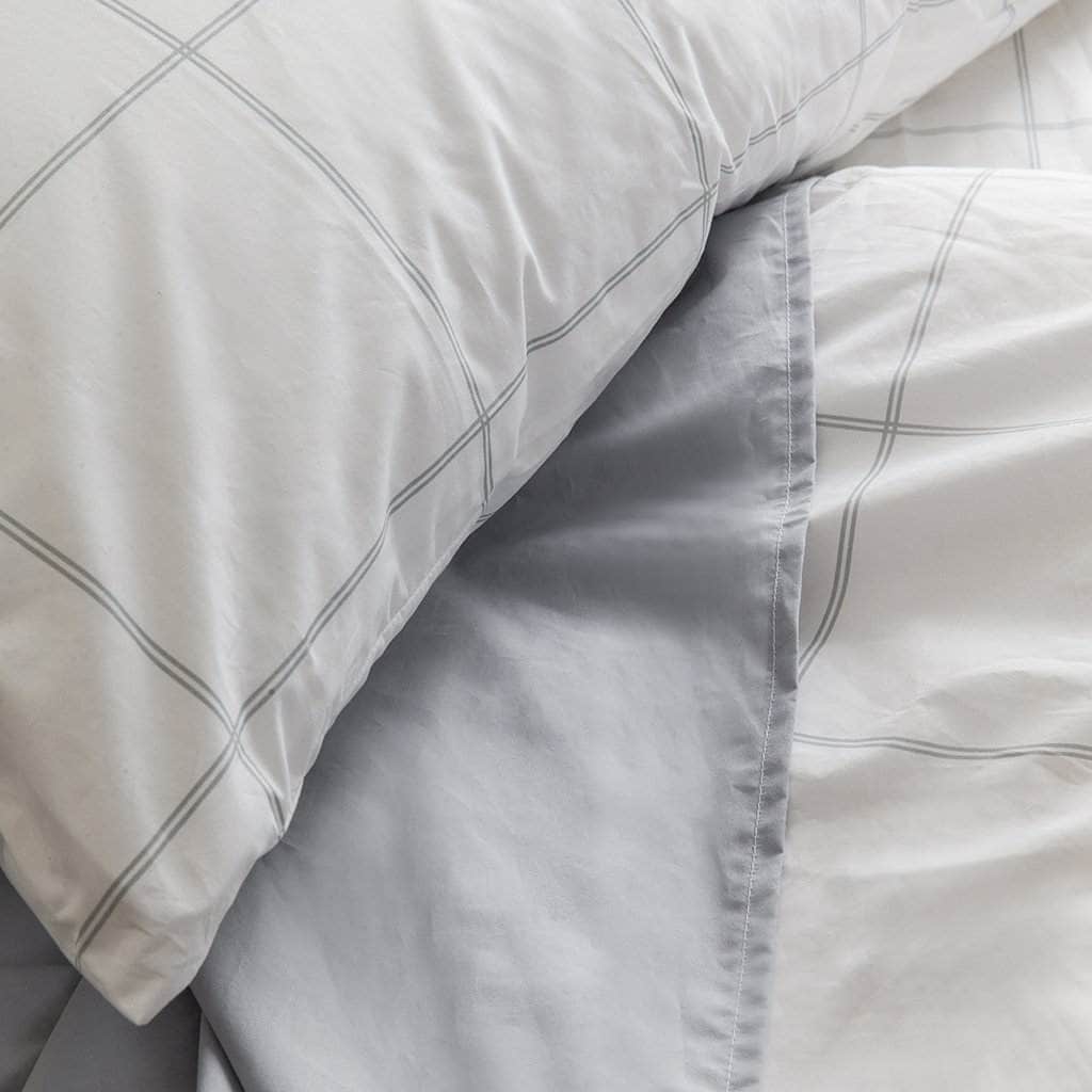 Close up of bed with Essential Collection Percale Sheet set in Light Grey Frame