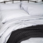 Close up of bed with Essential Collection Percale Sheet Set in Light Grey