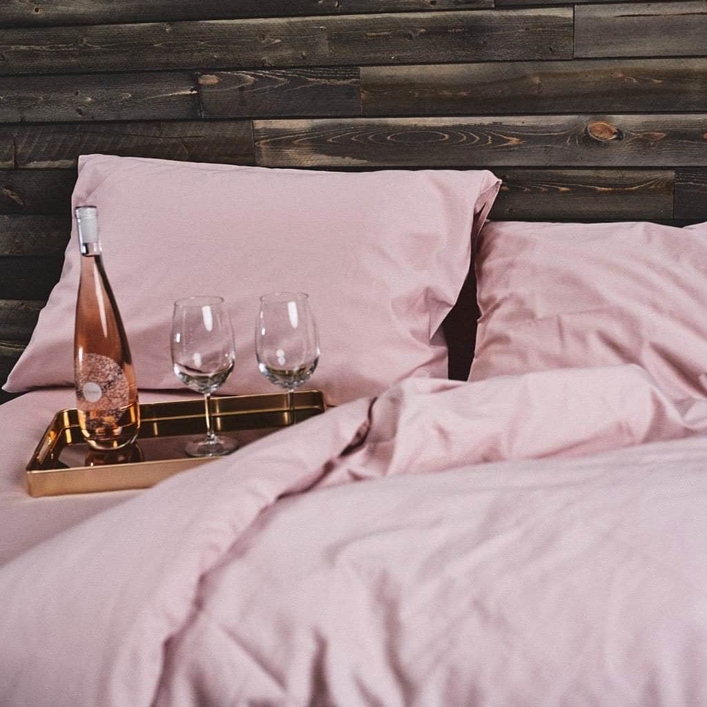  Dusty Rose Refined Sateen Sheet Set on bed with Rose and Glasses 