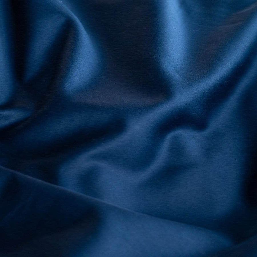 Close up navy blue sateen sheets