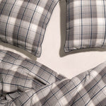 close up of 2 Navy and Chalk plaid pillow cases and duvet cover